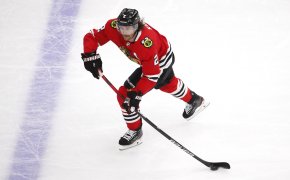 Chicago Blackhawks defenseman Duncan Keith handling the puck on the ice during an NHL game.