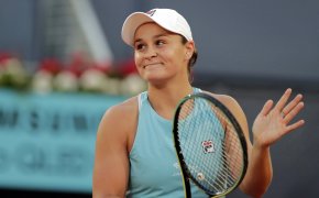 Ashleigh Barty clapping on her racket after winning a tennis match.