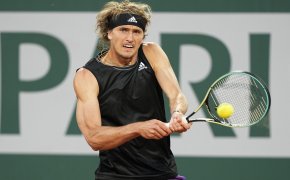 Alexander Zverev hitting a return to his opponent during a tennis match.