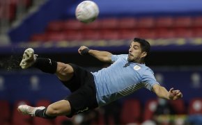 Uruguay's Luis Suarez taking a shot on net during a soccer match.