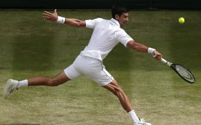 Novak Djokovic stretching for a return during a Wimbledon match