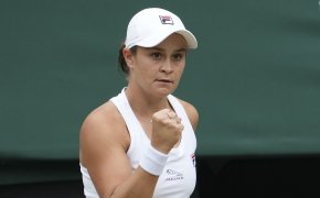 Ashleigh Barty celebrating winning a point with a fist pump.