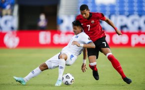 El Salvador defender Bryan Tamacas and Trinidad defender Ryan Telfer battling for the ball during a CONCACAF Gold Cup soccer match.