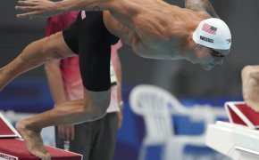 Caeleb Dressel dives into the pool