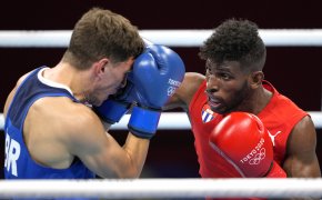 Cuba's Andy Cruz punching Britain's Luke McCormack during a boxing match at the Olympics.