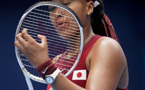 Naomi Osaka checking strings on racket