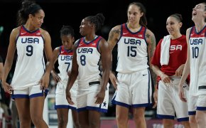 USA Women's Basketball players walking off the court after a win during the Olympics.