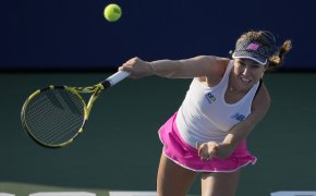 Danielle Collins hitting a return to her opponent during a tennis match.