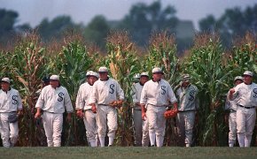 Persons portraying ghost players emerge from the cornfield at the 