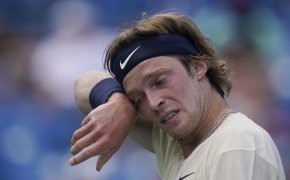 Andrey Rublev wiping face with wristband