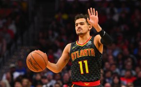 Trae Young dribbling with lift hand up