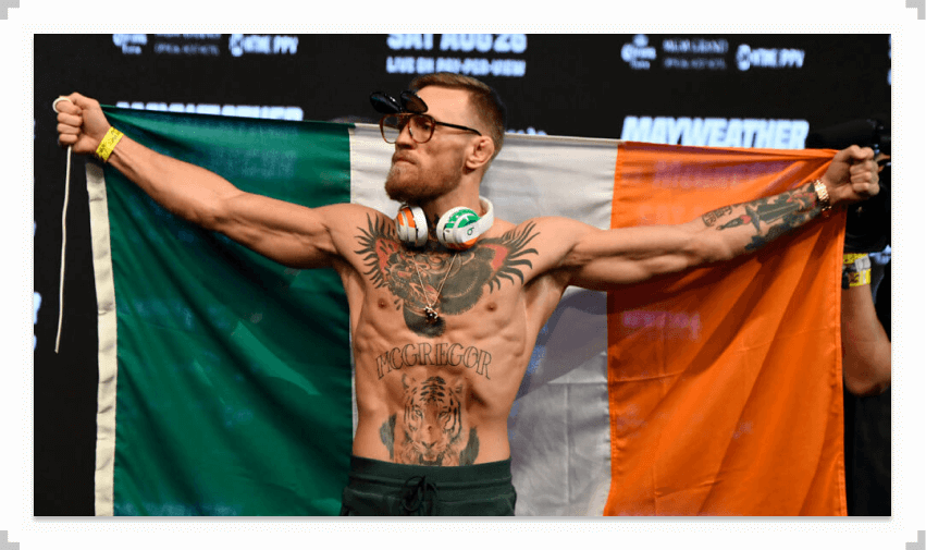 Conor McGregor holding Irish flag behind his back