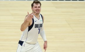 Luka Doncic holding up three fingers and sticking out tongue