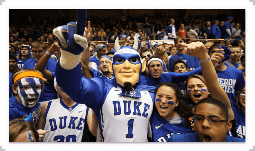 Duke mascot holding up one finger in a crowd