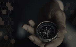 Compass in hand black background
