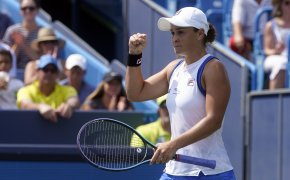 Ashleigh Barty reacting with a first pump during a tennis match.