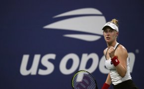 Alison Riske reacting with a fist pump during a tennis match.