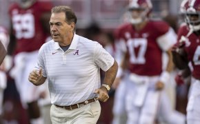 Alabama head coach Nick Saban leading his team onto the field before a game.