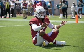 Arizona Cardinals quarterback Kyler Murray celebrating in the end zone after scoring a touchdown.