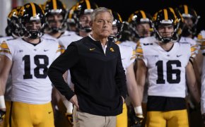 Iowa head coach Kirk Ferentz looking on to the field during a college football game.