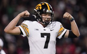 Iowa quarterback Spencer Petras reacting with his hands up in the air after a play during a NCAA college football game.