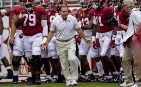Alabama head coach Nick Saban leading his team onto the field prior to a NCAA college football game.