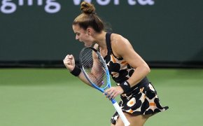 Maria Sakkari reacting to winning a point during a tennis match.