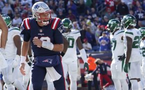 New England Patriots quarterback Mac Jones celebrating after a touchdown.