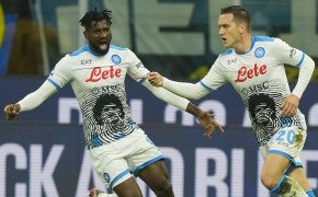 Napoli's Piotr Zielinski celebrating with his teammate after scoring a goal.