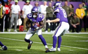 Minnesota Vikings quarterback Kirk Cousins handing the ball off to Dalvin Cook during a football game.