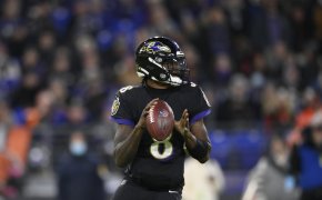Baltimore Ravens quarterback Lamar Jackson looking to throw the ball during a football game.