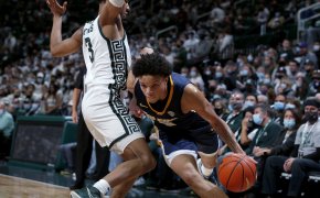 Toledo's Ryan Rollins driving pas a Michigan State defender