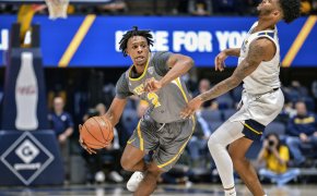 Kent State guard Malique Jacobs dribbling past a defender
