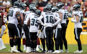 Philadelphia Eagles players huddling up during an NFL football game.