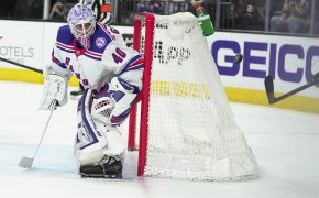 New York Rangers goaltender Alexander Georgiev defending the net during an NHL game,