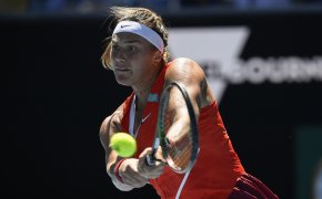 Aryna Sabalenka hitting a backhand return during a tennis match at the Australian Open.