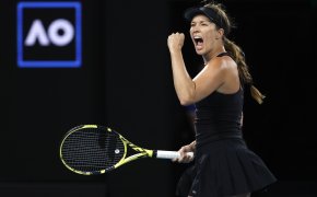 Danielle Collins reacting with a yell and fist pump after winning a point during a match at the 2022 Australian Open.