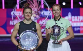 Maria Sakkari and Anett Kontaveit posing with their trophies after a final match.