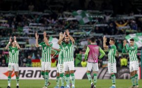 Betis players applaud to the crowd after the end of a game.