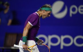 Rafael Nadal celebrating winning a point during a tennis match.