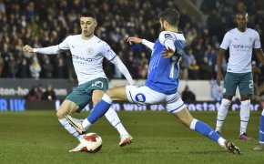 Manchester City's Phil Foden fighting for the ball during a soccer match.
