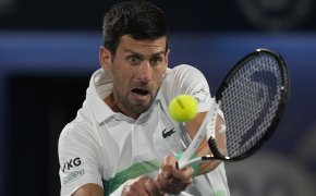 Novak Djokovic hitting a return during a tennis match.