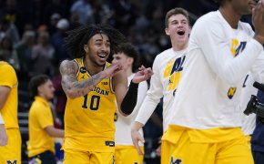 Michigan guard Frankie Collins celebrating a win over Colorado State with his teammates