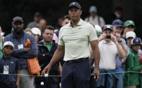 Tiger Woods watches a practice shot
