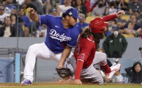 Los Angeles Dodgers relief pitcher Brusdar Graterol tags out a runner at third base