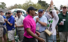 Tiger Woods walks past applauding fans