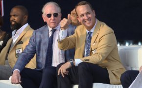 Peyton Manning thumbs up beige suit Archie Manning sunglasses blue suit