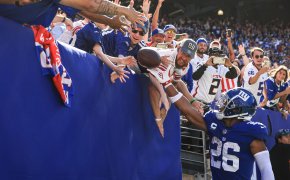 New York Giants Saquon Barkley throws football to fans