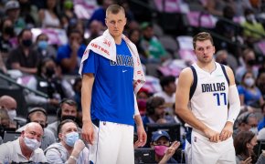 Kristaps Porzingis and Luka Doncic standing on the sidelines