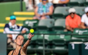 Karolina Pliskova throwing up a ball for a serve during a match.